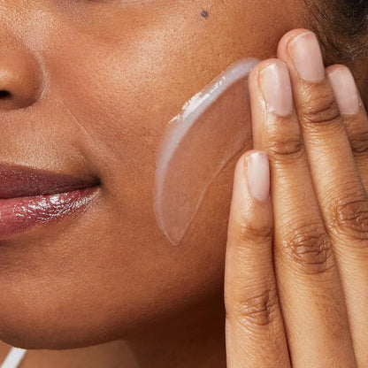 Close-up of a woman applying CeraVe Hydrating Cleanser to her face