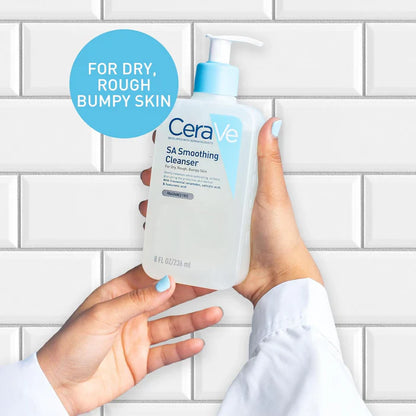 CeraVe SA Smoothing Cleanser held by a person against a tiled wall background