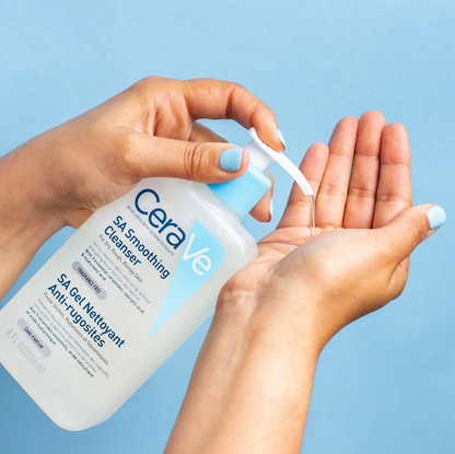 CeraVe SA Smoothing Cleanser being applied to hands against a blue background