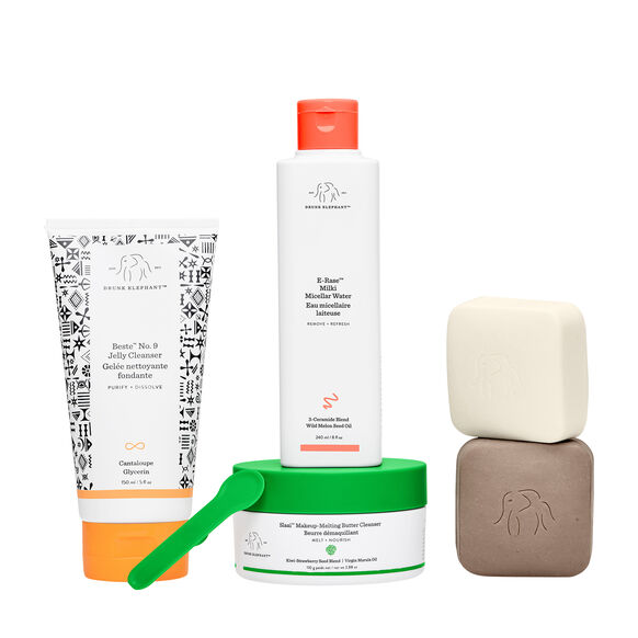 Collection of Drunk Elephant skincare products including a tube, bottle, jar, and bar on a white background