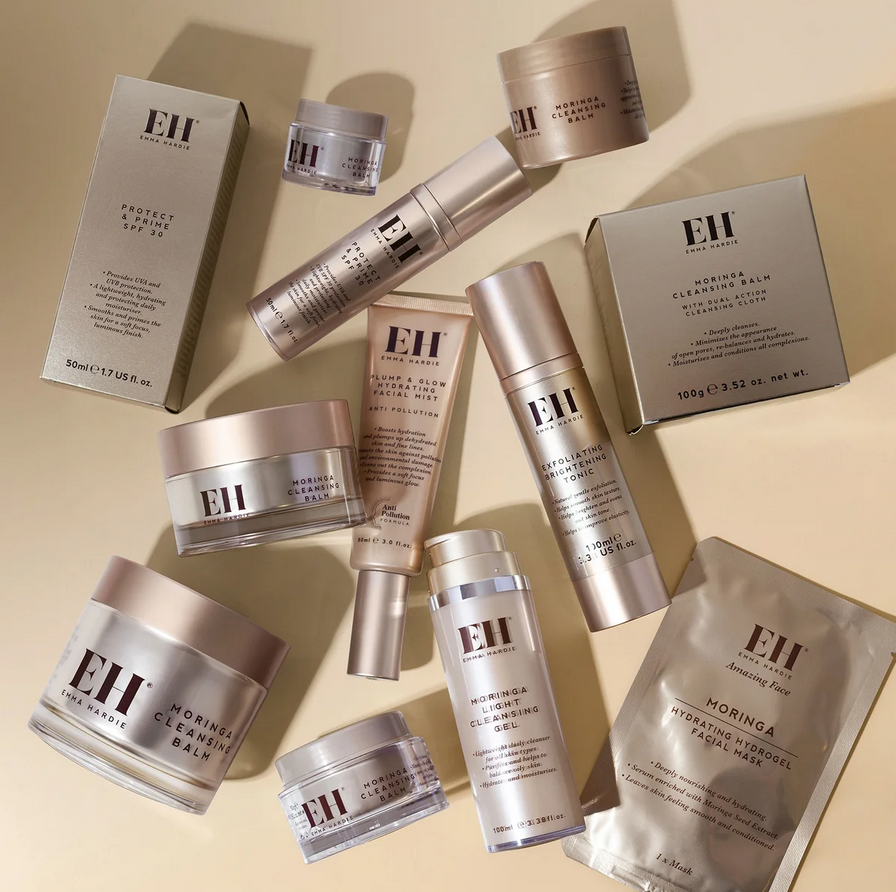 Collection of Emma Hardie skincare products on a beige background
