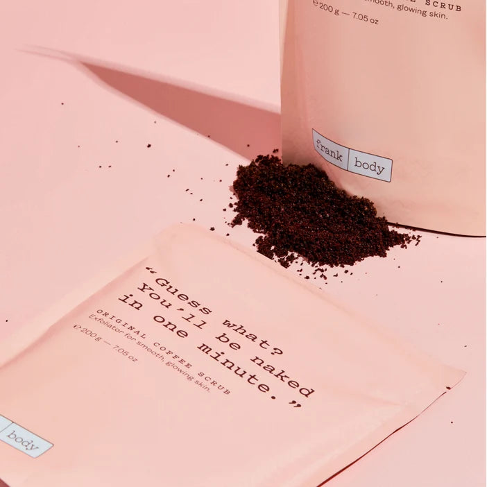 Pink packaging with coffee scrub and humorous text on a pink background