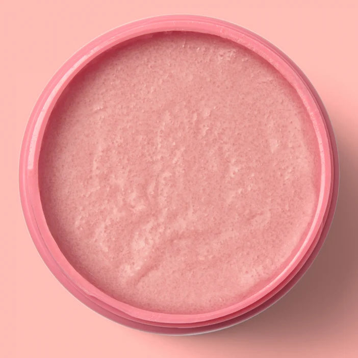 Pink cosmetic cream in a round container on a pink background