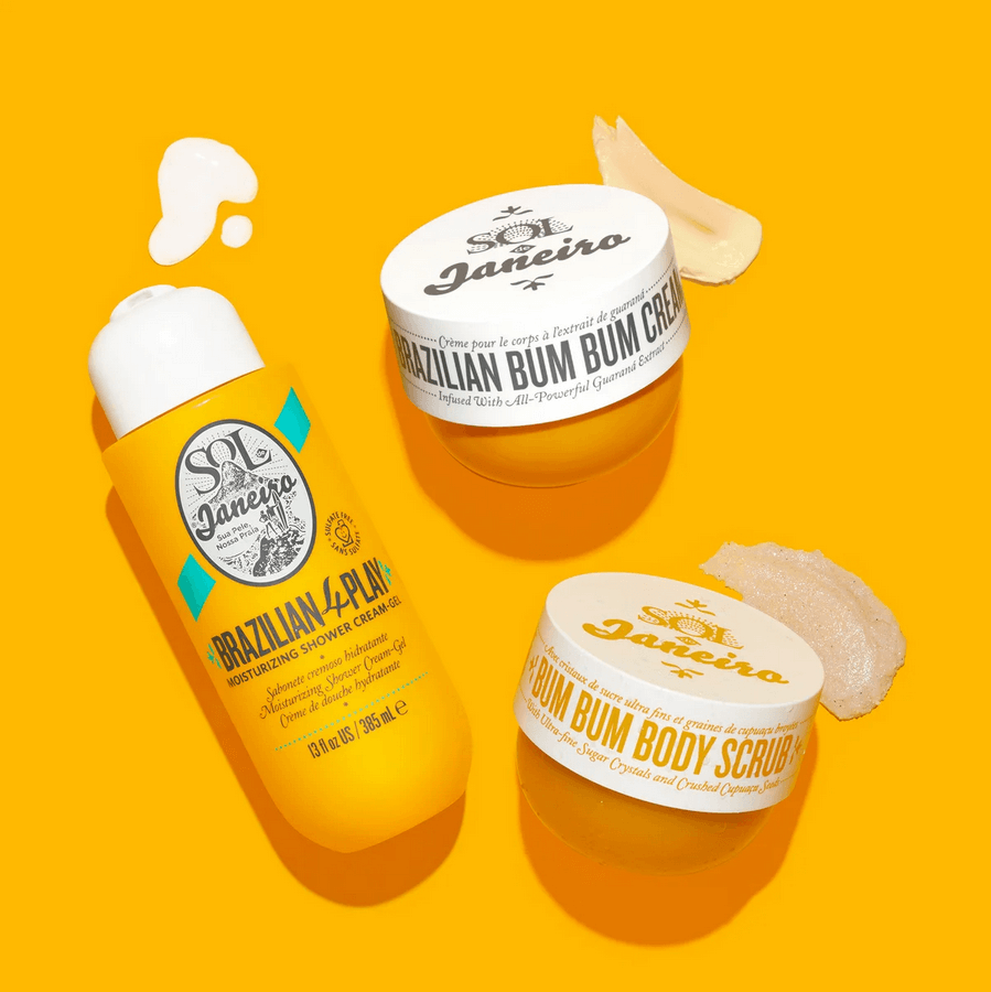 Sol de Janeiro Brazilian 4 Play Moisturizing Shower Cream-Gel and Bum Bum Body Scrub on vibrant yellow background.