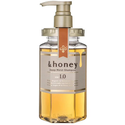 Bottle of '& honey' deep moist shampoo with pump on a white background