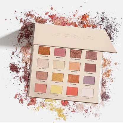 Iconic London Sunset to Sunrise Eyeshadow Palette: a Makeup palette featuring colour swatches on a white background with scattered makeup powder.