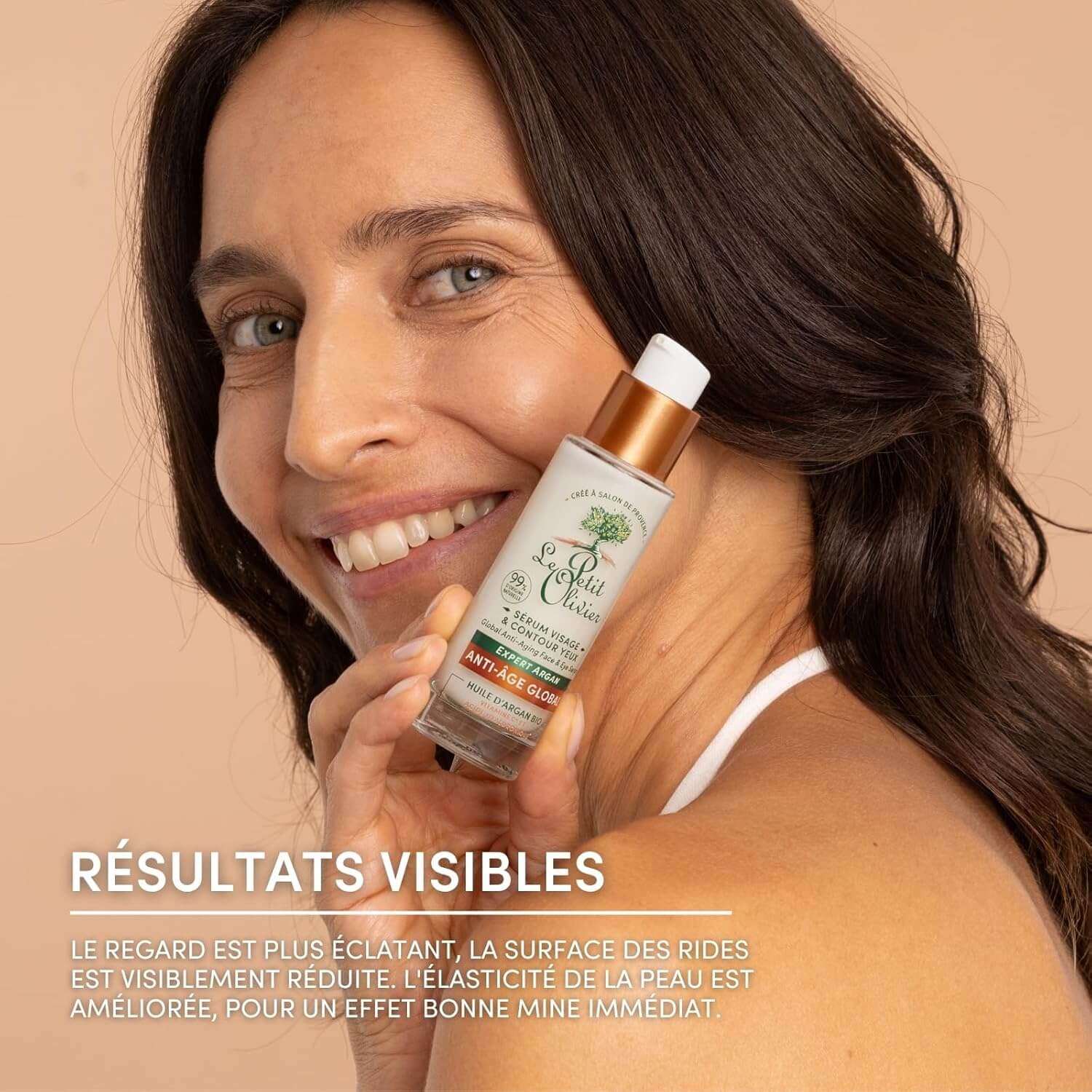 Woman holding Le Petit Olivier skincare bottle with text about visible results on a beige background