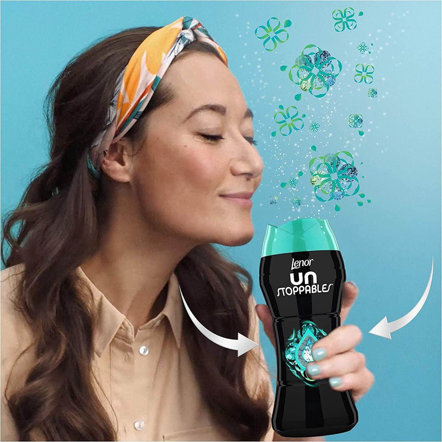 Woman enjoying the fresh scent of Lenor Unstoppables In-Wash Scent Booster with floral notes.