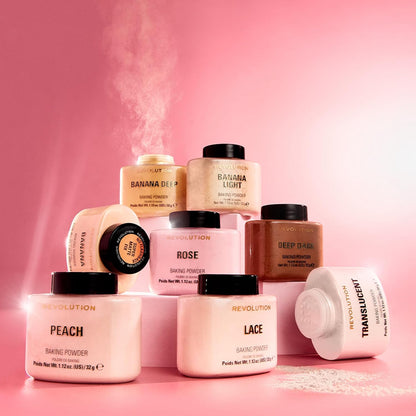 Collection of Makeup Revolution baking powder jars on a pink background
