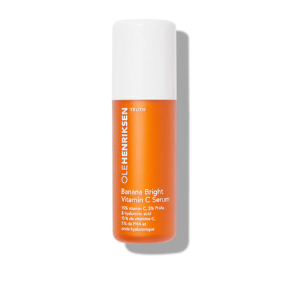 Orange serum bottle with white cap on a white background