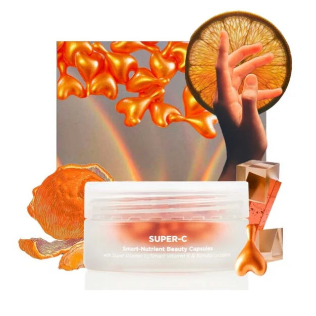 Oskia Super-C beauty capsules with orange slices and a hand holding an orange against a colorful abstract background.