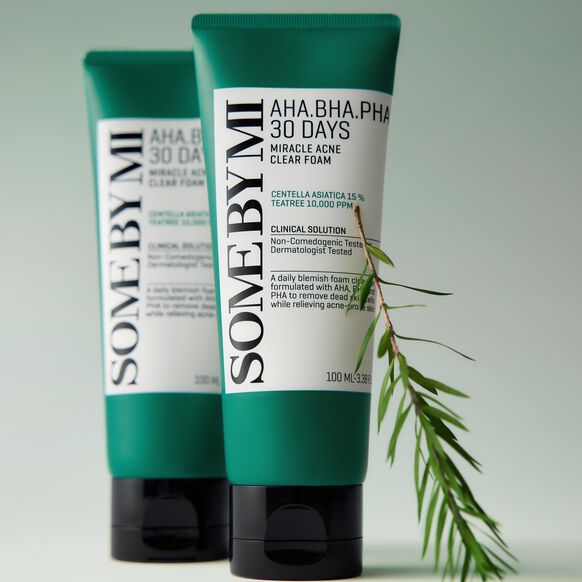 Two green skincare products with white labels on a light gray background