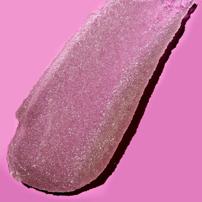 Pink glitteryTree Hut Desert Haze Sugar Scrub swatch on a pink background