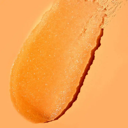 Close-up of TREE HUT Sugar Scrub Papaya Paradise 510g showing its orange, exfoliating texture on a soft background.