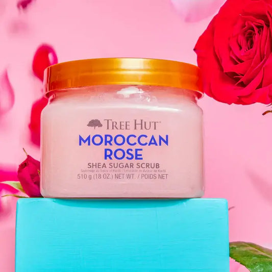 TREE HUT Moroccan Rose Shea Sugar Scrub 510g in a vibrant setting with roses.