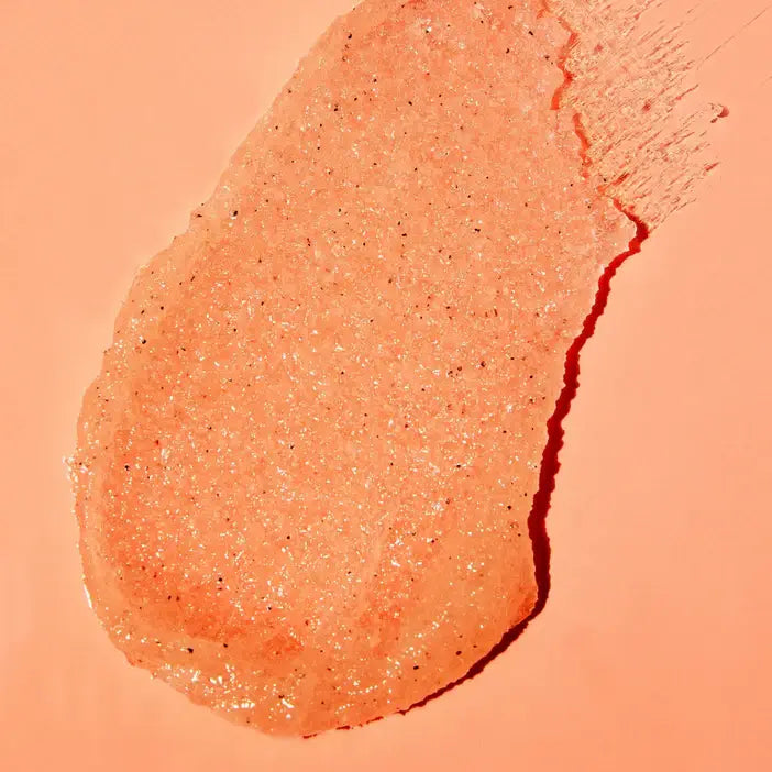 Close-up of a peach TREE HUT Vitamin C Sugar Scrub product on a matching background