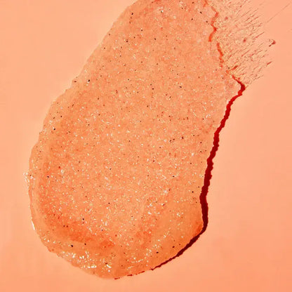 Close-up of a peach TREE HUT Vitamin C Sugar Scrub product on a matching background