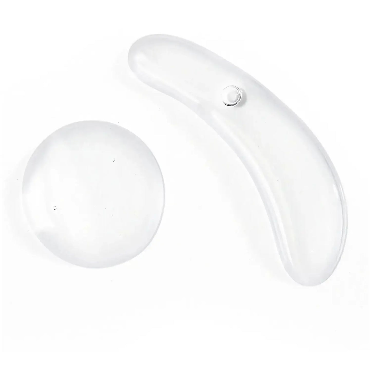 Transparent facial massage tools for skin care, including a curved and a round shape for effective application.