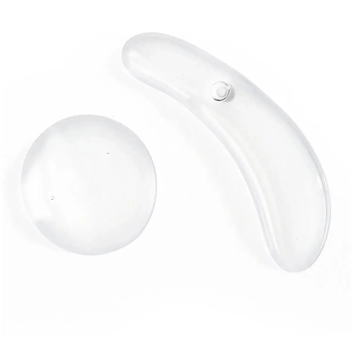 Transparent facial massage tools for skin care, including a curved and a round shape for effective application.