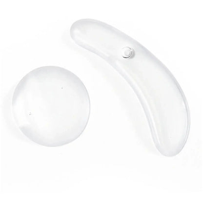 Transparent facial massage tools for skin care, including a curved and a round shape for effective application.