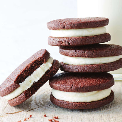 Delicious ASDA Cookies & Cream Biscuits stacked on a wooden surface, ideal for a sweet treat with milk.