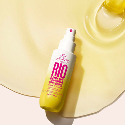 Sol de Janeiro Rio Radiance Oil SPF 50 body oil on a glossy surface for hydration and sun protection.