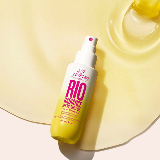 Sol de Janeiro Rio Radiance Oil SPF 50 body oil on a glossy surface for hydration and sun protection.