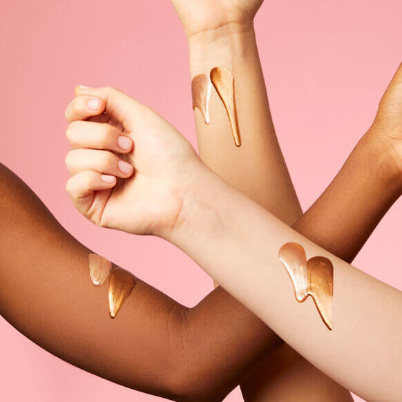 Sol de Janeiro Copacabana Bronze Glow Oil glistening on diverse skin tones, showcasing a radiant bronzed finish.