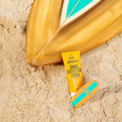 Sol de Janeiro Samba 2-Step Foot Fetish Care 90ml on sandy beach next to surfboard.