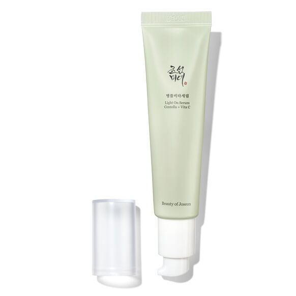 A light green squeeze tube of Beauty of Jerusalem Light Oil Serum with Korean text on the front, shown next to its clear cap on a white background with a soft shadow.