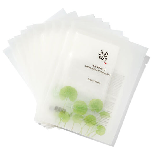 Stack of facial masks with green design and visible brand on a white background