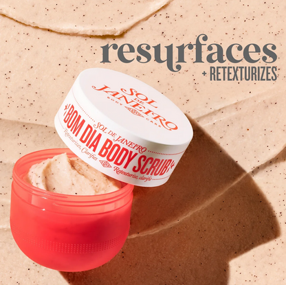 Sol de Janeiro Bom Dia Body Scrub 220g in a pink jar on exfoliating surface, promotes skin resurfacing and retexturizing.
