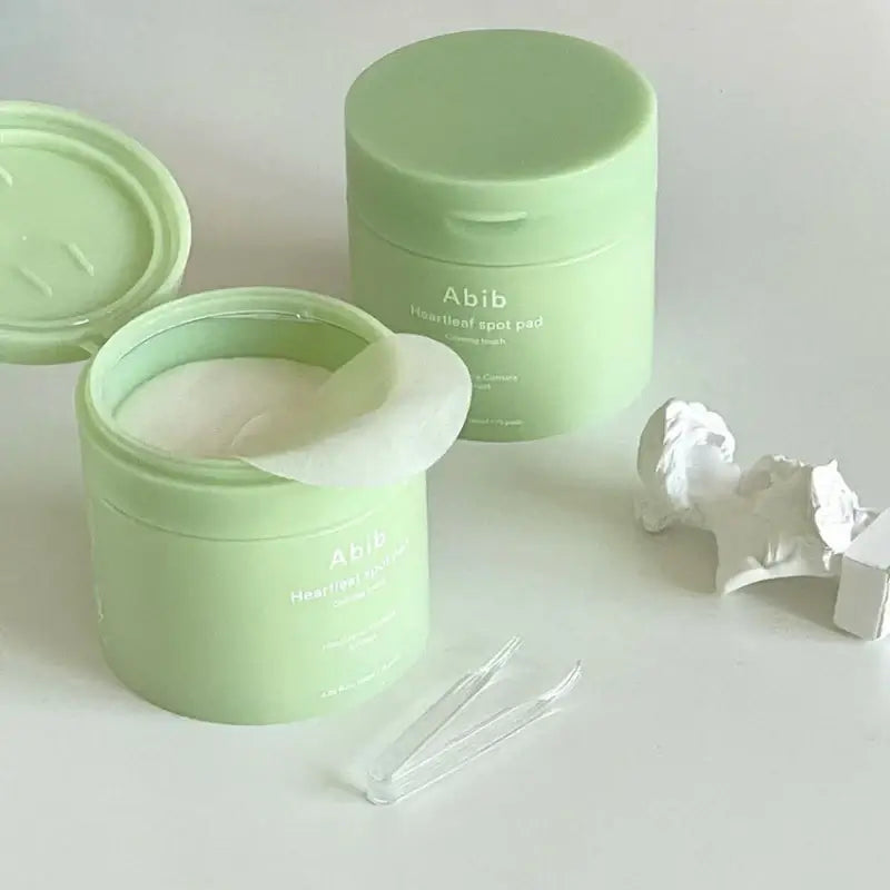 ABIB Heartleaf Spot Pad in green container, showcasing calming skincare pads for radiant complexion.