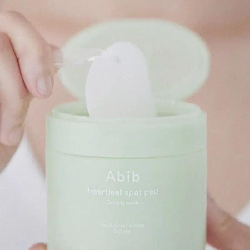 Person holding Abib Heartleaf Spot Pad, showcasing gentle skincare for a radiant complexion.