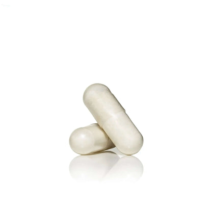 Two white capsules of Advanced Nutrition Programme™ Skin Youth Biome on a reflective surface.