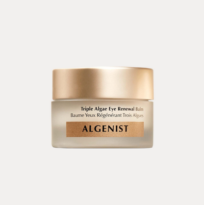 Algenist Triple Algae Eye Renewal Balm in a frosted glass jar with a metallic gold lid, shown on a light gray background.