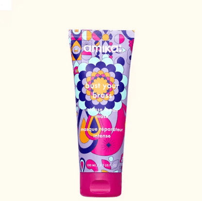 Amika Bust Your Brass Cool Blonde Intense Repair Hair Mask tube designed for illuminating blonde hair.