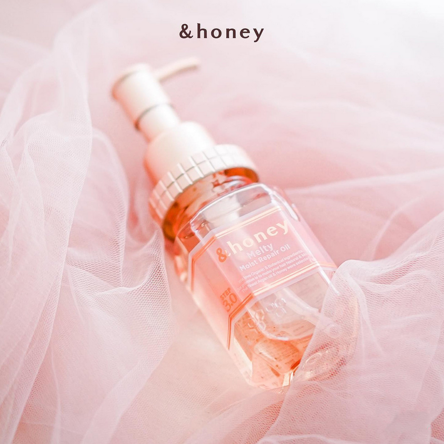 Skincare serum bottle with 'honey' branding on a soft pink background