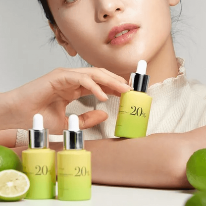 ANUA Green Lemon Vita C 20% Blemish Serum with model, lemon background highlighting brightening effects.