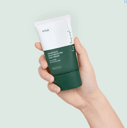 Anua Heartleaf Silky Moisture Sun Cream in hand, showcasing SPF 50+ protection and sleek packaging.