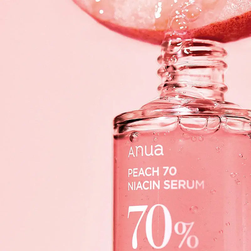 Anua Peach 70% Niacinamide Serum bottle with pink background, promoting radiant and moisturized skin.