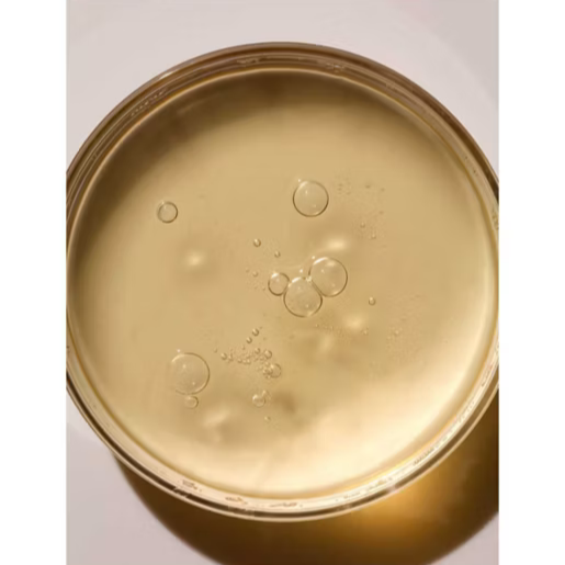 Close-up of ARKIVE All Day Everyday Conditioner in a glass jar, showcasing its luxurious golden texture.