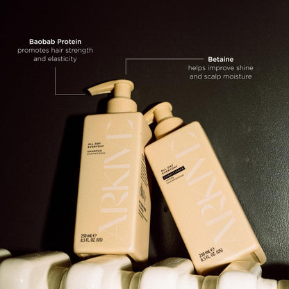 Two bottles of ARKIVE 'All Day Everyday' shampoo and conditioner with text on benefits on a dark background.