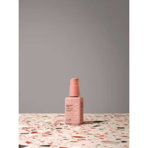 ARKIVE The Good Habit Hybrid Oil 50ml on a patterned surface for healthy-looking hair care.
