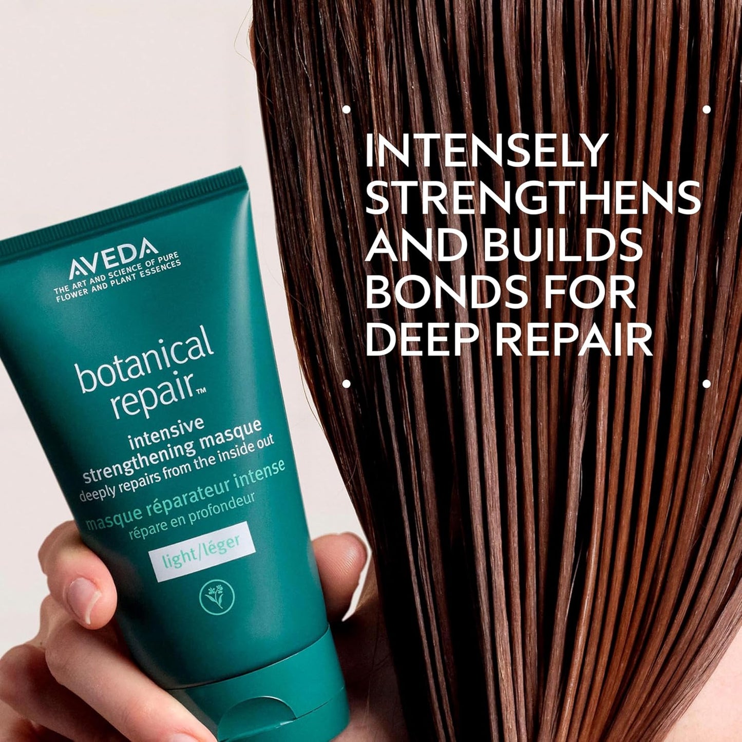 Aveda botanical repair intensive strengthening masque with text about deep repair on a white background