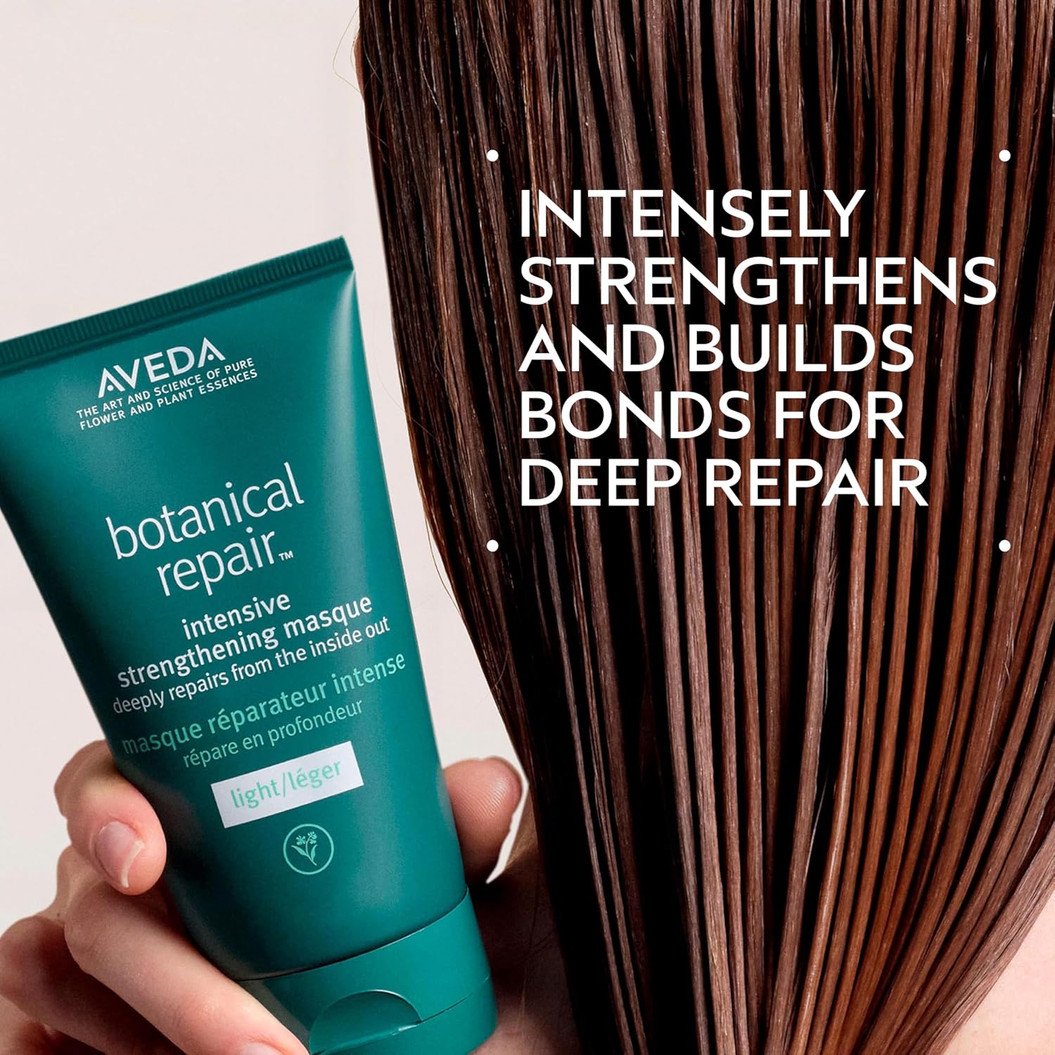 Aveda botanical repair intensive strengthening masque with text about deep repair on a white background