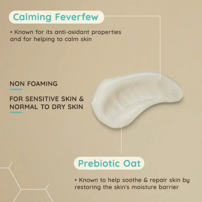 Product with text about Aveeno calming feverfew, non-foaming properties, and prebiotic oat benefits on a beige background.