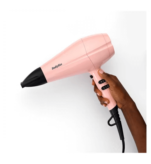 BaByliss Rose Blush Hair Dryer in hand, lightweight design, featuring 2200W power and advanced airflow technology.