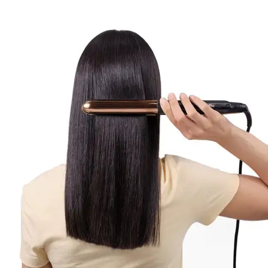 Woman using BaByliss Rose Gold Straightener on long, sleek hair for smooth, polished styling.