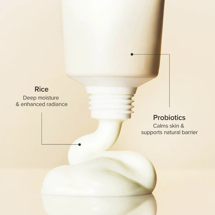 Skincare product with text highlighting rice and probiotics on a beige background